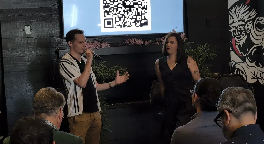 An OpenCLE host and guest speaking in front of the audience