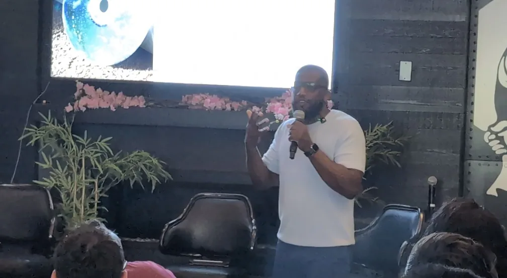 An OpenCLE presenter demonstrating a device onstage